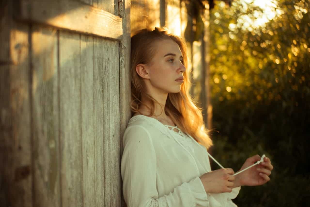 woman-wearing-white-top-leaning-on-wooden-wall-2726046-1654134312.jpg